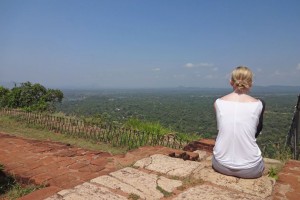 Blonde haired girl admiring the view from the top of Sigiriya in Sri Lanka