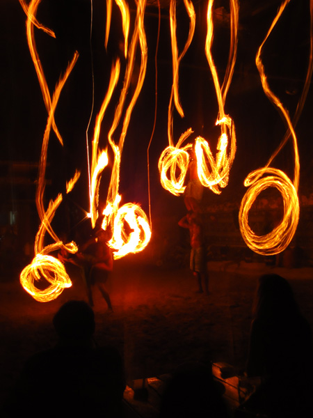 Swirls of light caught from Fijian dancers spinning fire batons
