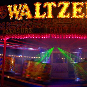 Waltzer ride lit up at a funfair