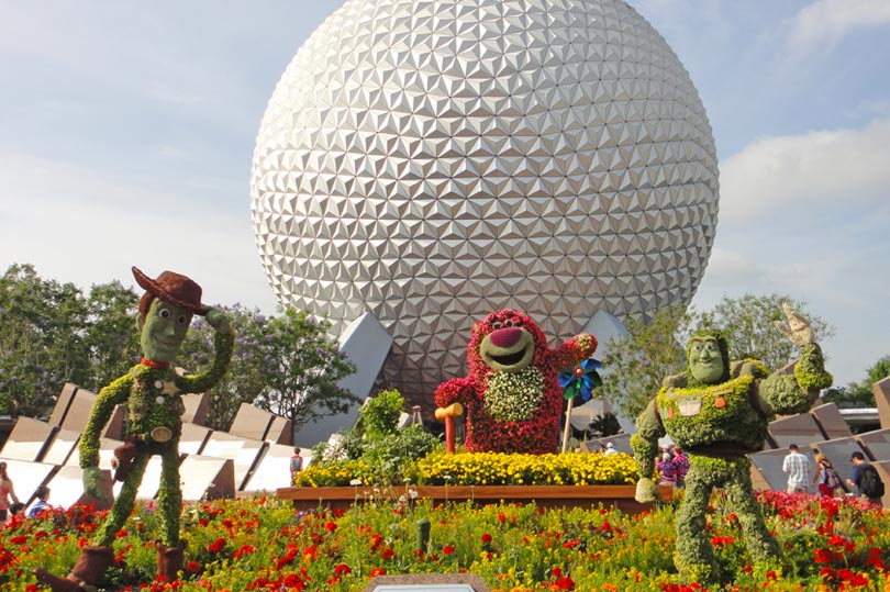 Spaceship Earth at Epcot featuring Toy Story topiary for the Flower and Garden Festival